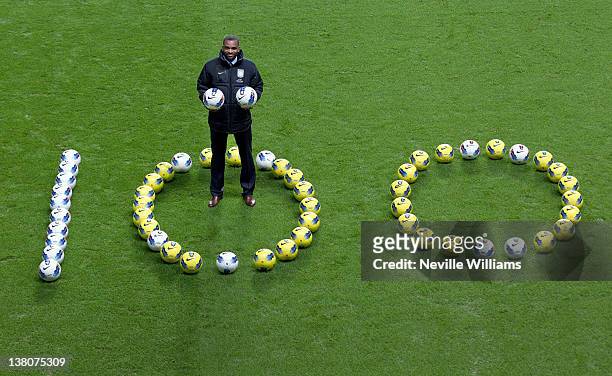 Darren Bent of Aston Villa poses for a photo to celebrate scoring his 100th career Barclays Premier League goal during the game between Aston Villa...