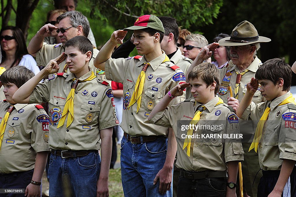 Members of the Boy Scouts salute during