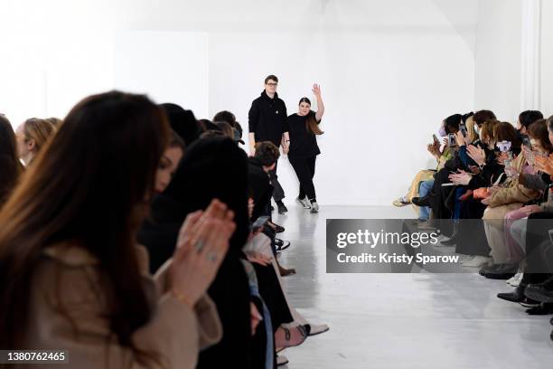 Designers Balthazar Delepierre and Ester Manas acknowledge the audience during the Ester Manas Womenswear Fall/Winter 2022-2023 show as part of Paris...