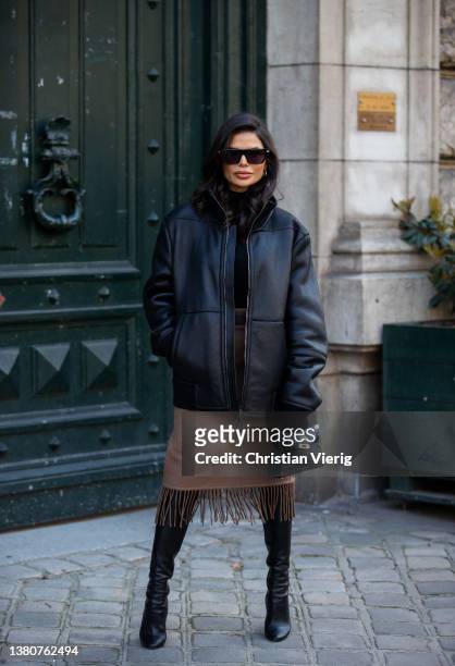 Victoria Barbara seen wearing black leather jacket, brown skirt with fringes, Hermes bag, over knees boots, turtleneck, sunglasses outside Hermes...