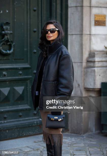 Victoria Barbara seen wearing black leather jacket, brown skirt with fringes, Hermes bag, over knees boots, turtleneck, sunglasses outside Hermes...