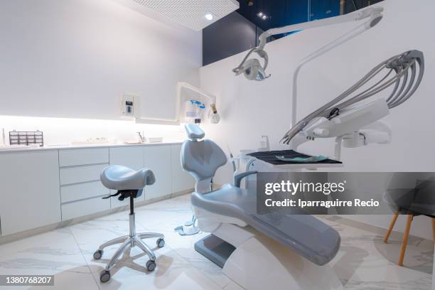 facilities of a modern dental clinic. dental practice room interior with chair, lamp, screen and stomatology tools - tandarts stockfoto's en -beelden