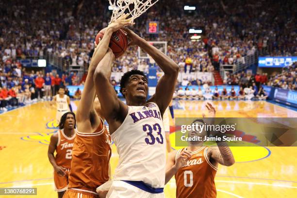 David McCormack of the Kansas Jayhawks jumps to dunk the ball against Andrew Jones of the Texas Longhorns in the first half of the game at Allen...