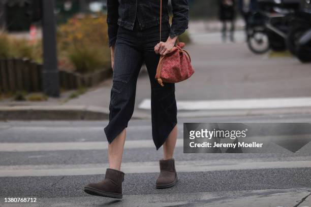 Veronika Heilbrunner seen wearing dark denim jeans jacket, dark blue cropped jeans, ugg mini boots in brown and a Loewe bag on March 04, 2022 in...