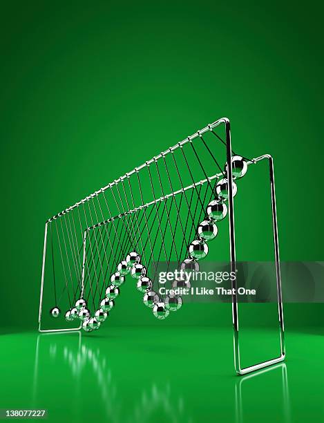 newtons cradle with growth graph chart depicted - domino stock-fotos und bilder