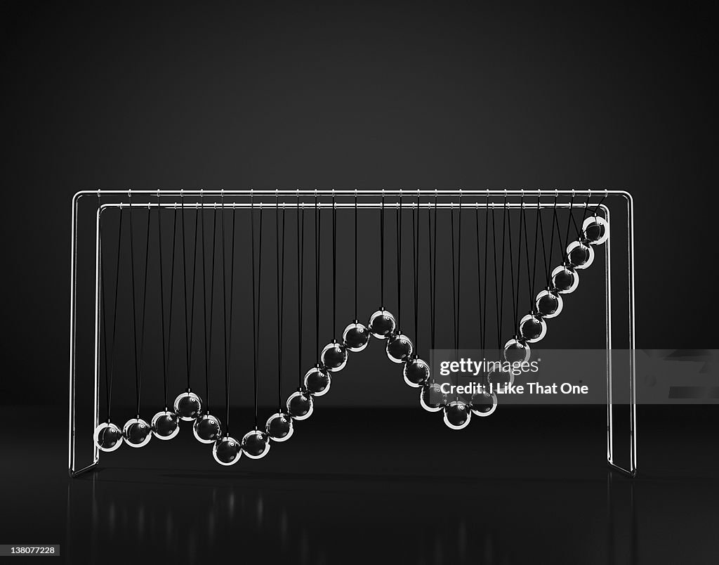 Newtons Cradle with growth graph chart depicted