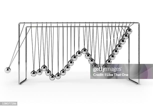 newton's cradle depicting positive graph chart - movimiento perpetuo fotografías e imágenes de stock