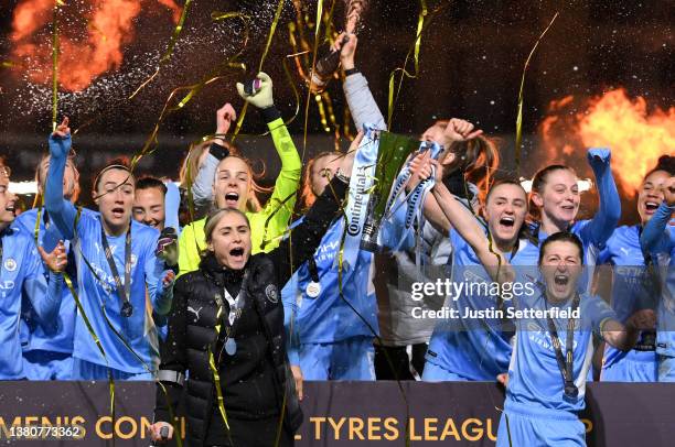 Steph Houghton and Ellen White of Manchester City lift the FA Women's Continental Tyres League cup trophy following their side's victory in the FA...