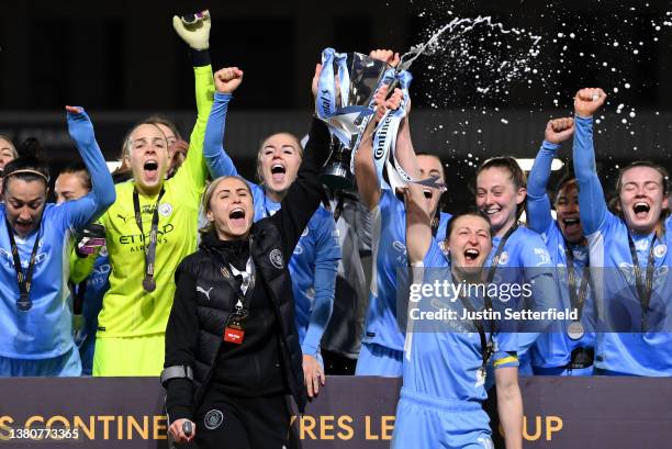 Steph Houghton and Ellen White of Manchester City lift the FA Women's Continental Tyres League cup trophy following their side's victory in the FA...