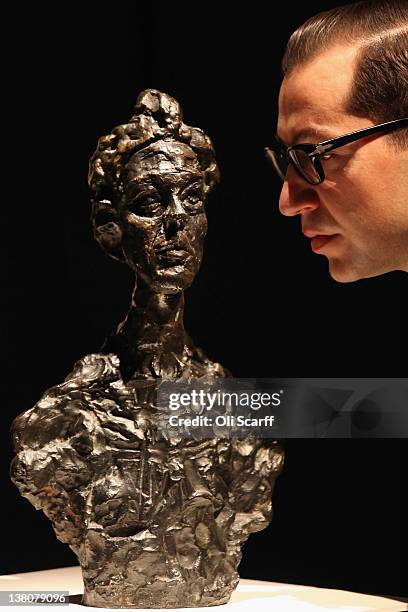 Gallery assistant at Christie's auction house admires a sculpture by Alberto Giacometti entitled "Annette Venise" on February 2, 2012 in London,...