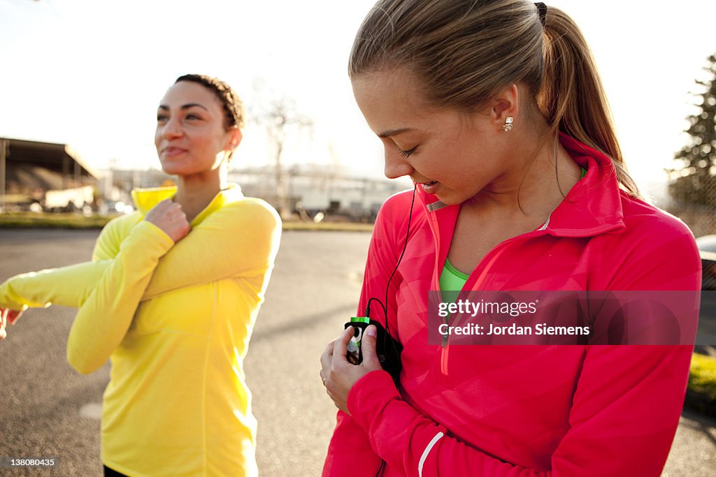 Two females running with  an mp3 player.