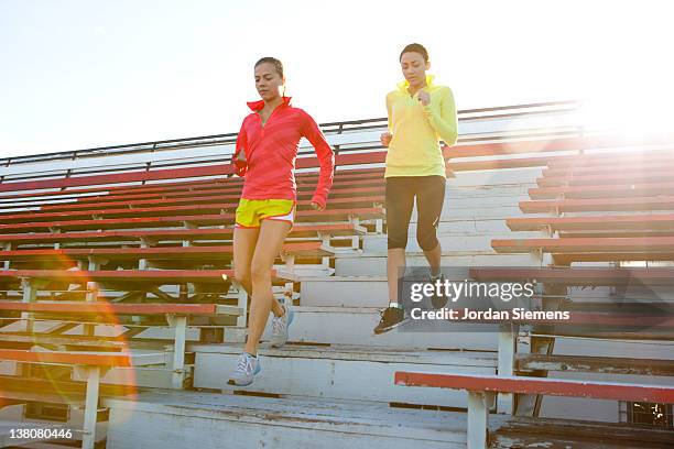 two women exercising. - shorts down stock pictures, royalty-free photos & images