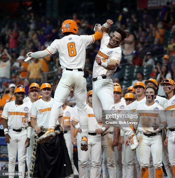 Christian Scott of the Tennessee Volunteers receives a high five from Jorel Ortega after hitting a two run home run in the third inning against the...