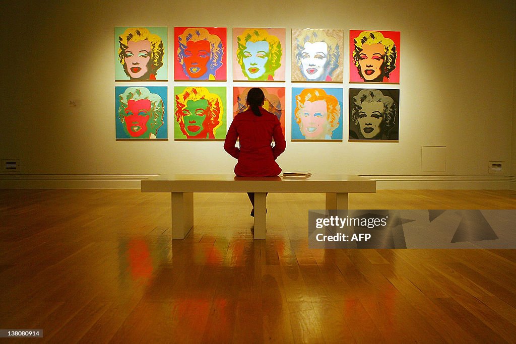 A visitor examines Andy Warhol's Marilyn