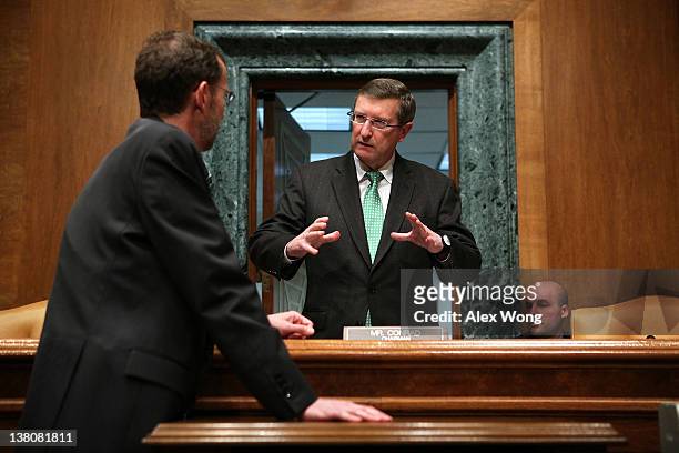Committee chairman Sen. Kent Conrad talks to Director of the Congressional Budget Office Douglas Elmendorf prior to a hearing before the Senate...
