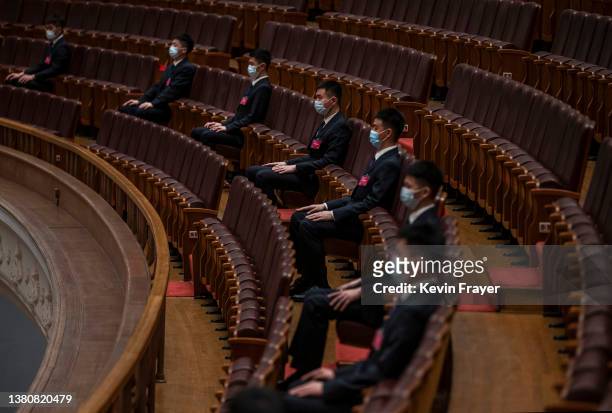 Security sit in seats in the gallery at the opening session of the National Peoples Congress at the Great Hall of the People on March 5, 2022 in...
