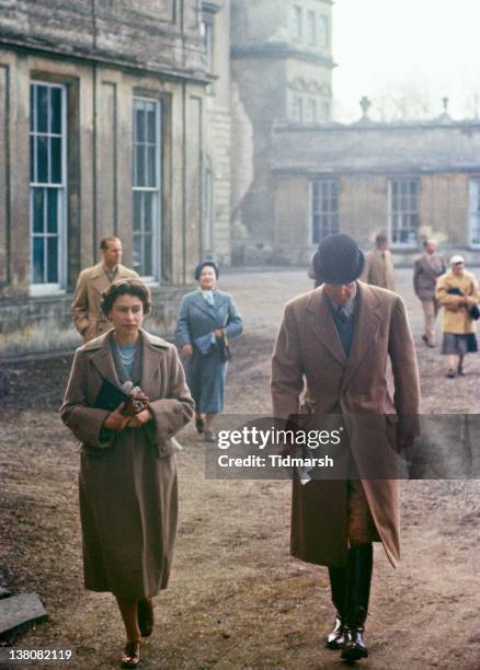 Queen Elizabeth II at Badminton House, Gloucestershire, for the Badminton Horse Trials, April 1956. In the background are Prince Philip, Duke of...