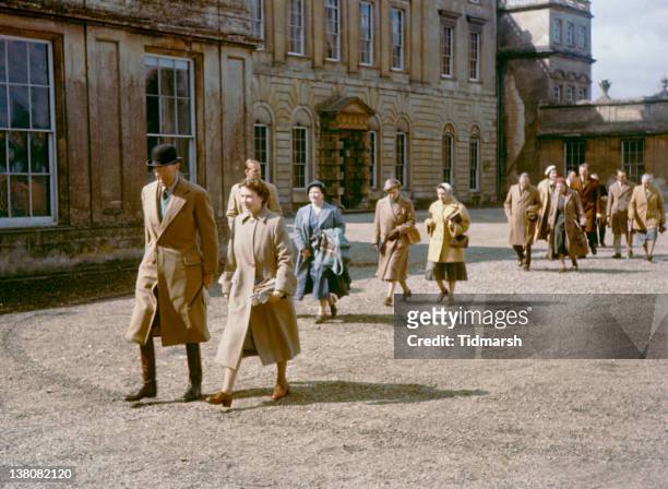 Queen Elizabeth II at Badminton House, Gloucestershire, for the Badminton Horse Trials, April 1956. Behind her are Prince Philip, Duke of Edinburgh...