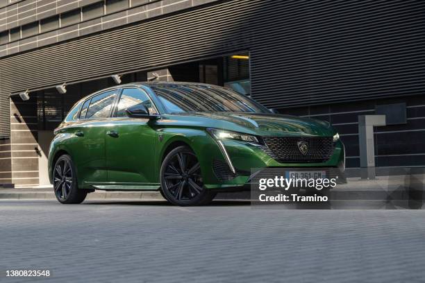 peugeot 308 hybrid 225 on a street - peugeot stock pictures, royalty-free photos & images