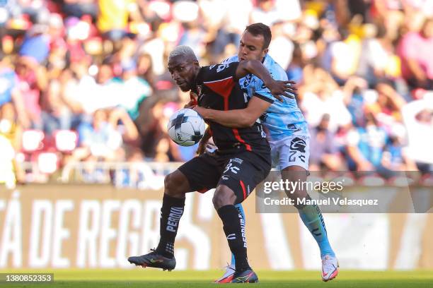 Julián Quiñones of Atlas struggles for the ball against Omar Mendoza of Querétaro during the 9th round match between Queretaro and Atlas as part of...