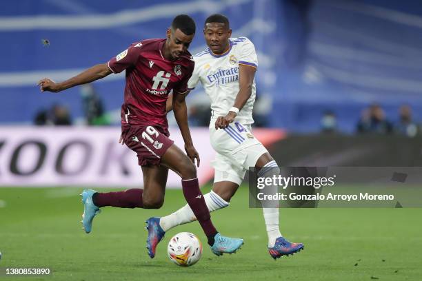 Alexander Isak of Real Sociedad de Futbol competes for the ball with David Alaba of Real Madrid CF during the LaLiga Santander match between Real...