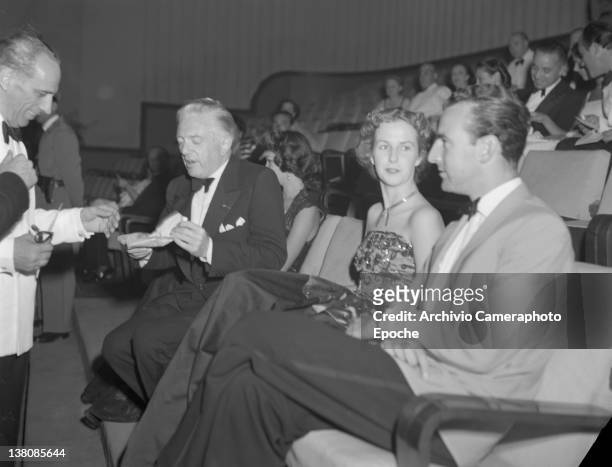 American actress Betsy Blair sitting with Luparini and Litvack in the front row during the Venice Movie Festival, 1949. American Actress