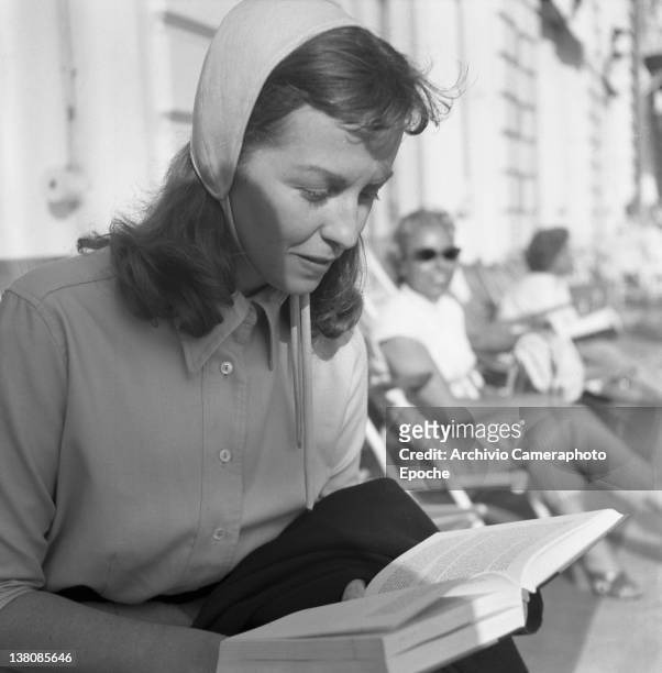 American actress Betsy Blair portrayed while reading a book, Cannes, 1955.