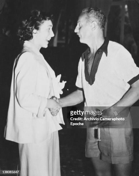American actress Betsy Blair shaking hands to Darryl Francis Zanuck, Venice, Lido, 1949.