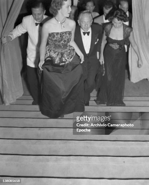 American actress Betsy Blair wearing an evening dress, portrayed while getting up the stairs, Lido, Venice, 1949.
