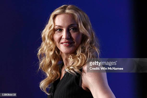 Singer Madonna looks on on during a press conference for the Bridgestone Super Bowl XLVI halftime show at the Super Bowl XLVI Media Center in the...