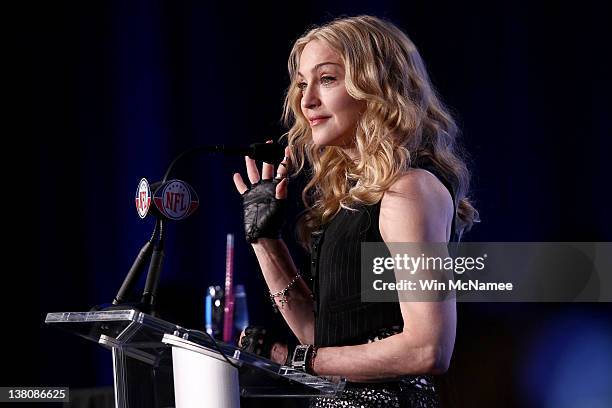 Singer Madonna speaks at the podium during a press conference for the Bridgestone Super Bowl XLVI halftime show at the Super Bowl XLVI Media Center...