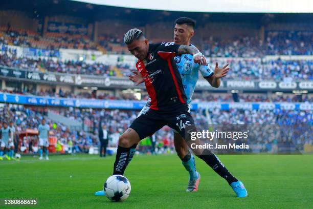 Luis Reyes of Atlas fights for the ball with Leonardo Sequeira of Queretaro during the 9th round match between Queretaro and Atlas as part of the...