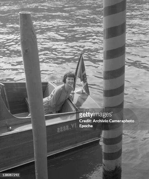 American actress Betsy Blair portrayed while sitting on a water taxi, Venice, 1960.