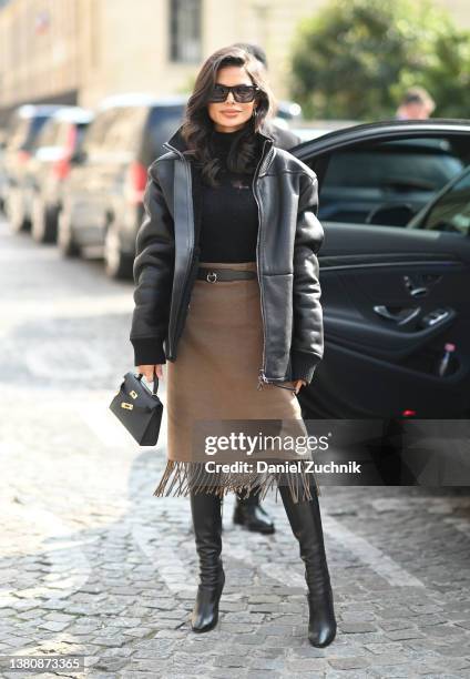 Victoria Barbara is seen wearing a Hermes outfit, YSL boots and Givenchy sunglasses outside the Hermes show during Paris Fashion Week A/W 2022 on...