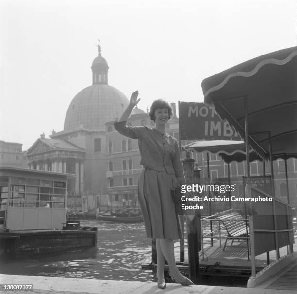 American actress Betsy Blair portrayed while waving outside the railway station, Venice, 1960.