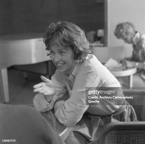 American actress Betsy Blair portrayed while chatting with someone, Lido, Venice, 1960.