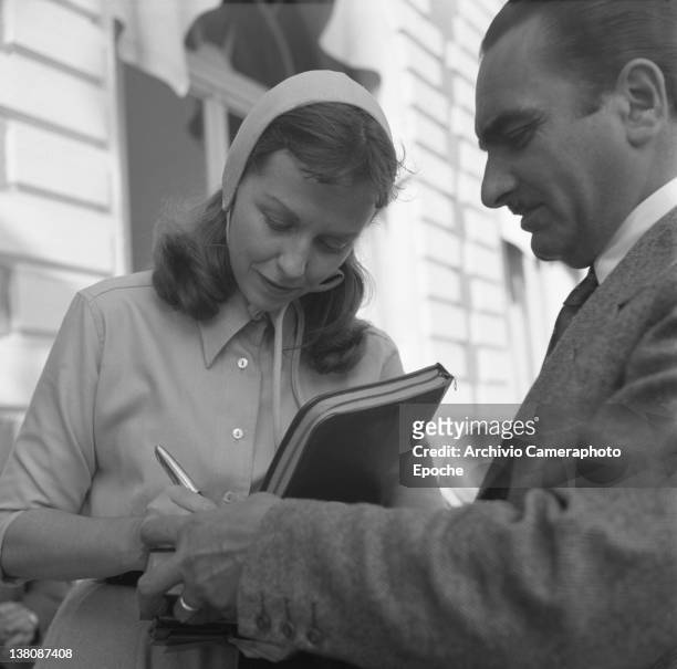 American actress Betsy Blair portrayed while signing an autograph, Cannes, 1950.