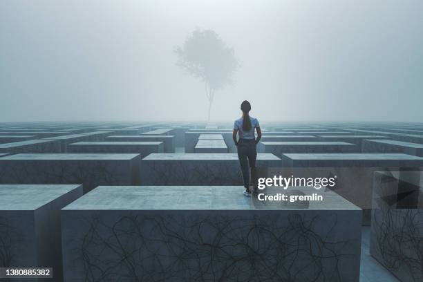 young woman standing in fantasy maze - magical thinking stock pictures, royalty-free photos & images