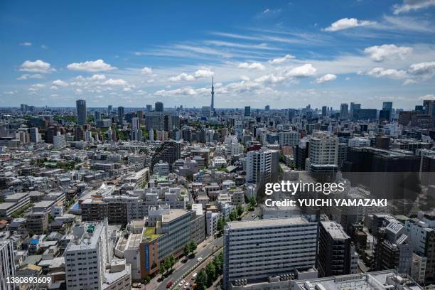 The city skyline is seen as the Tokyo Skytree looms in the background in Tokyo on July 2, 2023.