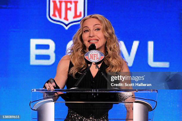 Singer Madonna speaks at the podium during a press conference for the Bridgestone Super Bowl XLVI halftime show at the Super Bowl XLVI Media Center...