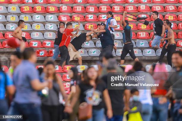 Fans of Atlas fight against fans of Queretaro during the 9th round match between Queretaro and Atlas as part of the Torneo Grita Mexico C22 Liga MX...