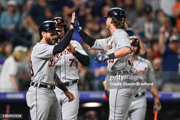 Zach McKinstry of the Detroit Tigers celebrates with Eric Haase and Jonathan Schoop after hitting a 10th inning three-run home run against the...