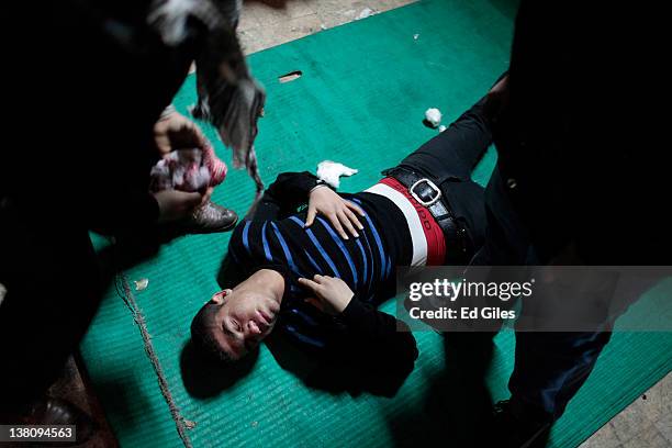 Protester suffering from the effects of tear gas inhalation is treated in a triage unit February 2, 2012 in Cairo, Egypt. The protest follows the...