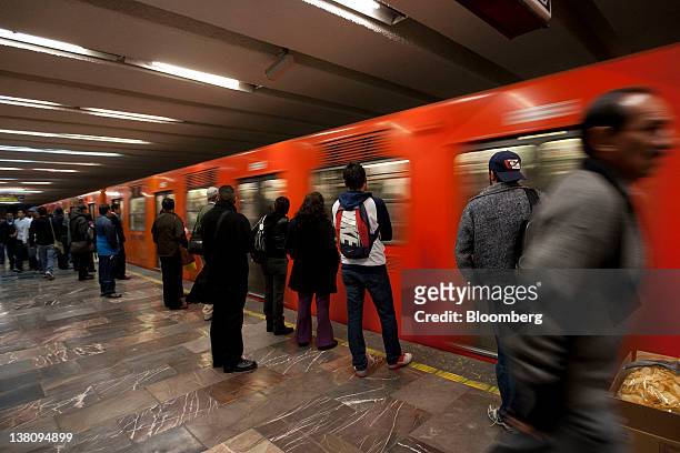 Commuters wait to board a subway train in Mexico City, Mexico, on Monday, Jan. 30, 2012. The Mexico City Metro, officially called Sistema de...