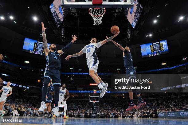Cole Anthony of the Orlando Magic goes to the basket against Ziaire Williams of the Memphis Grizzlies during the first half at FedExForum on March...