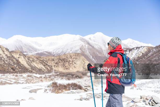 asian mid adult trekking in the wilderness area of the tibetan plateau - snowcapped mountain stock pictures, royalty-free photos & images