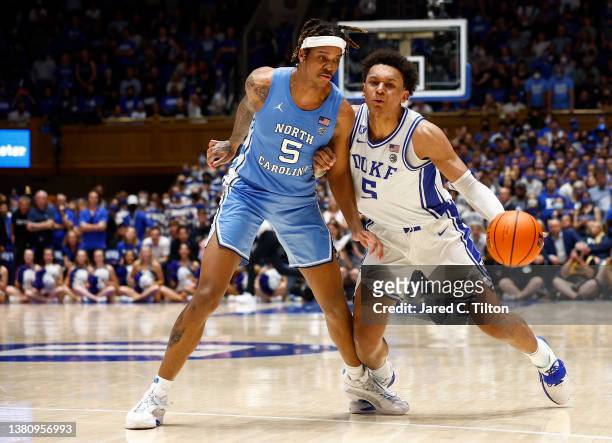 Paolo Banchero of the Duke Blue Devils dribbles against Armando Bacot of the North Carolina Tar Heels during the second half at Cameron Indoor...