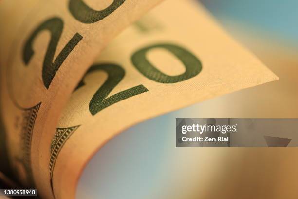 two american twenty-dollar bills against blurry background - billete-de-veinte-dólares-estadounidense fotografías e imágenes de stock