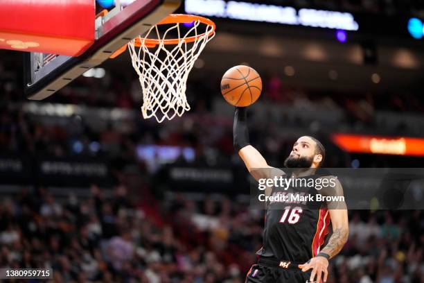 Caleb Martin of the Miami Heat scores on a break away dunk against the Philadelphia 76ers in the second half at FTX Arena on March 05, 2022 in Miami,...