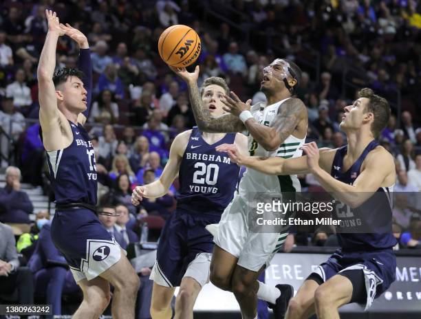 Khalil Shabazz of the San Francisco Dons is fouled as he drives to the basket against Alex Barcello, Spencer Johnson and Trevin Knell of the Brigham...